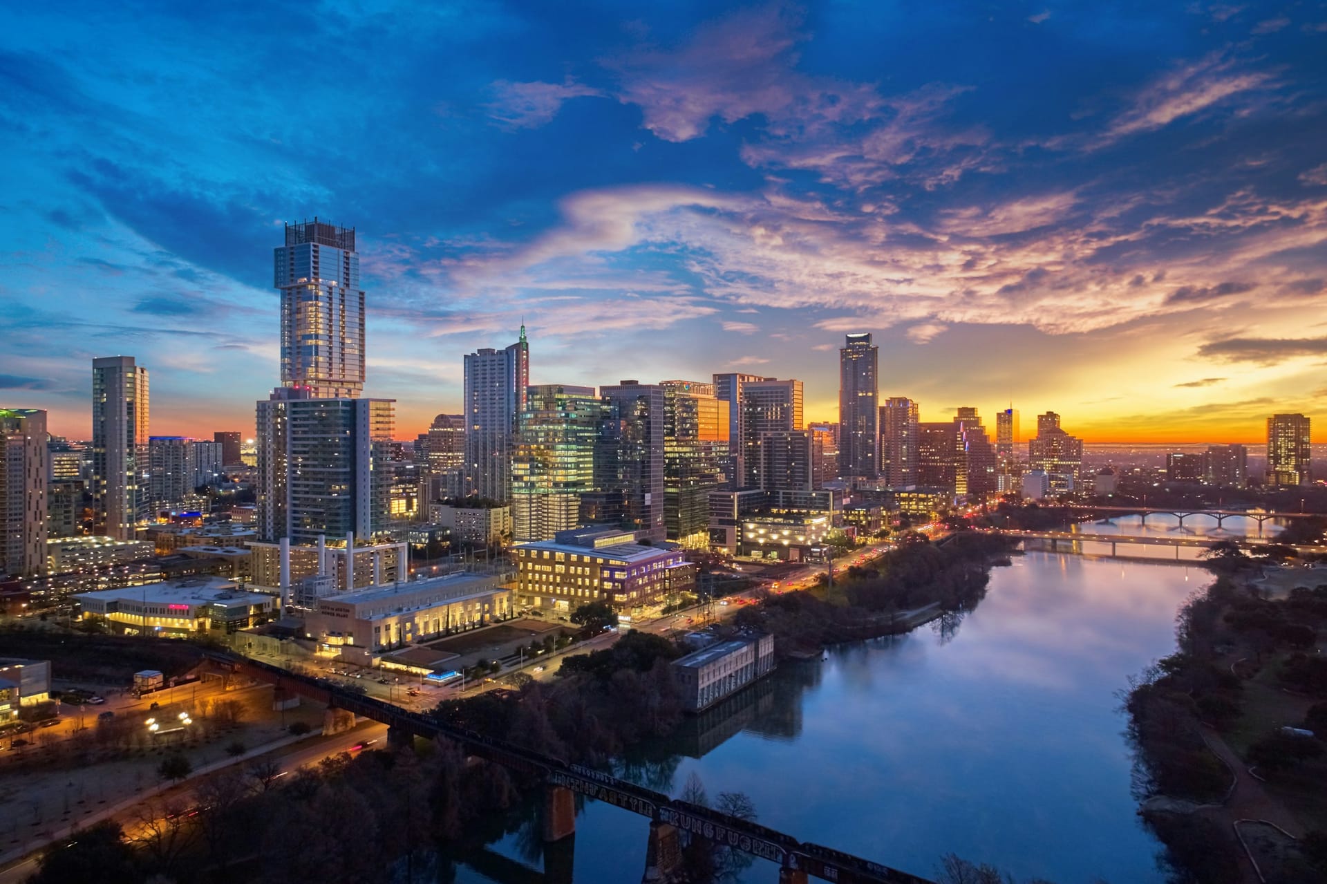 The downtown Austin skyline at sunset, seen across Lady Bird Lake