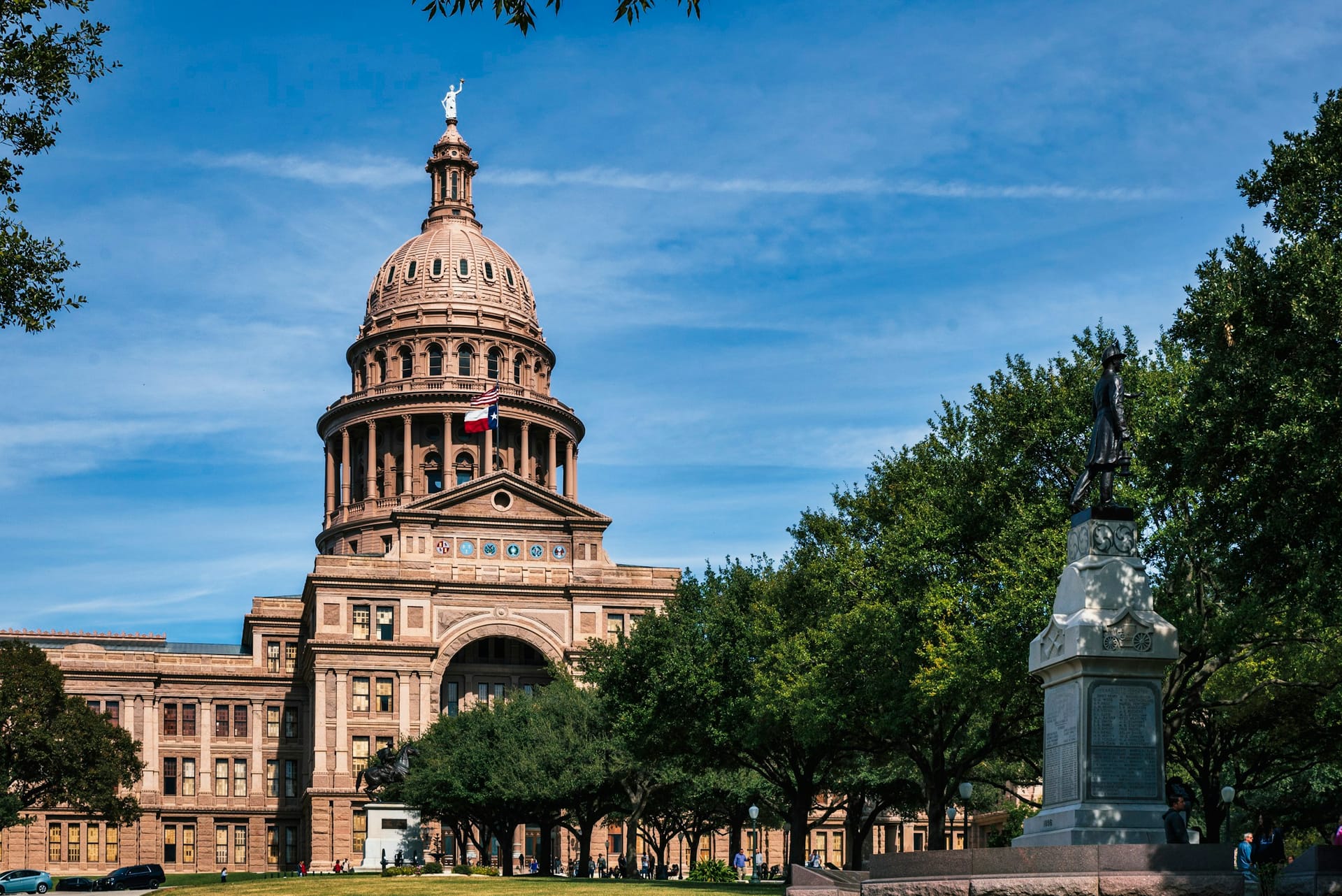 The dome of the Texas State Capitol with the Texas flag