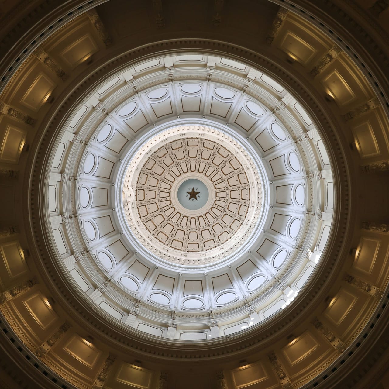 The rotunda dome of the Texas State Capitol seen from below, the lone star at its centre
